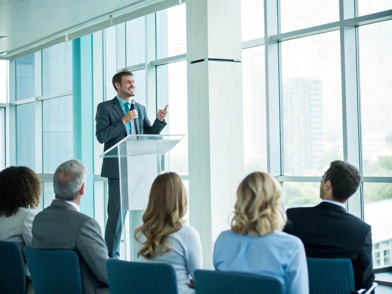 A Canadian business professional confidently presenting at a conference, showcasing career advancement and expertise.